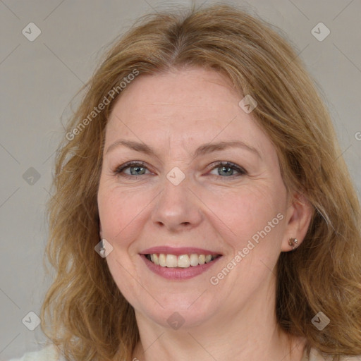 Joyful white adult female with medium  brown hair and blue eyes