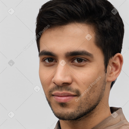 Joyful white young-adult male with short  black hair and brown eyes