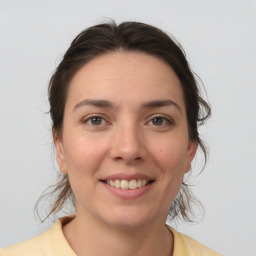 Joyful white young-adult female with medium  brown hair and brown eyes