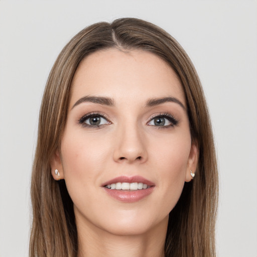 Joyful white young-adult female with long  brown hair and grey eyes