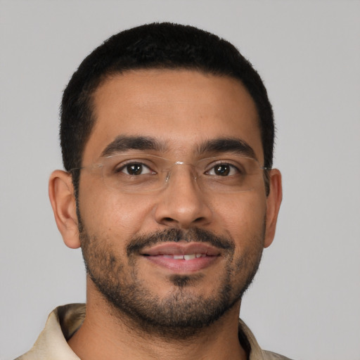 Joyful latino young-adult male with short  brown hair and brown eyes