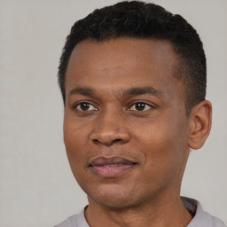 Joyful black young-adult male with short  black hair and brown eyes