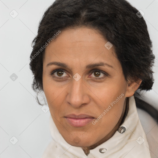 Joyful latino adult female with medium  brown hair and brown eyes