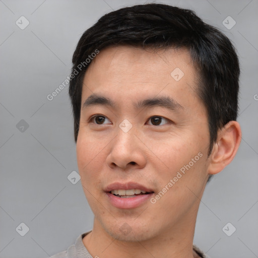 Joyful asian young-adult male with short  black hair and brown eyes