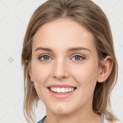 Joyful white young-adult female with medium  brown hair and blue eyes