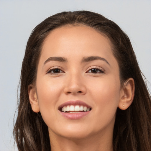 Joyful white young-adult female with long  brown hair and brown eyes