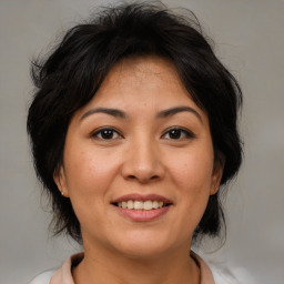 Joyful white adult female with medium  brown hair and brown eyes