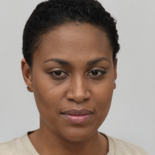 Joyful black young-adult female with short  brown hair and brown eyes