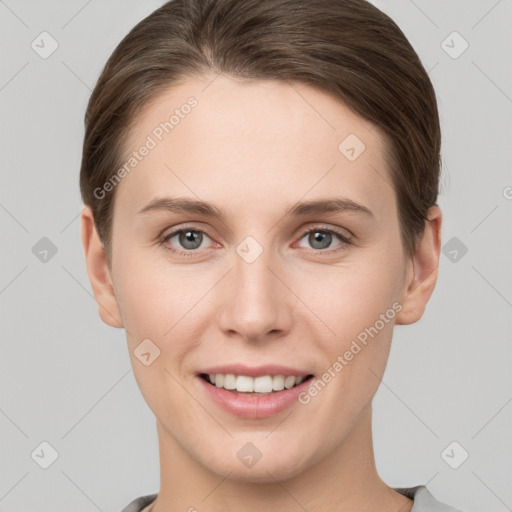 Joyful white young-adult female with short  brown hair and grey eyes