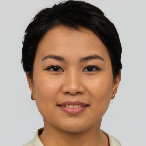 Joyful asian young-adult female with short  brown hair and brown eyes