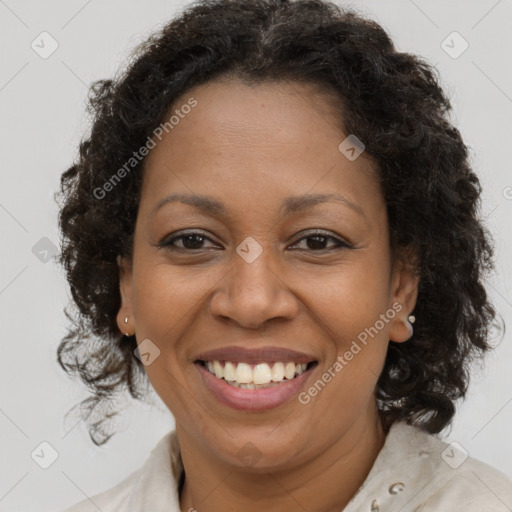 Joyful black adult female with medium  brown hair and brown eyes