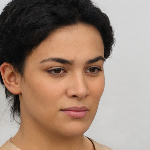 Joyful latino young-adult female with short  brown hair and brown eyes