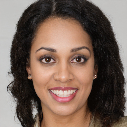 Joyful latino young-adult female with long  brown hair and brown eyes