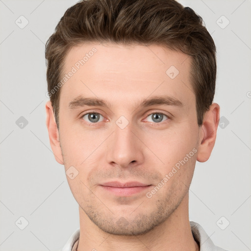 Joyful white young-adult male with short  brown hair and grey eyes