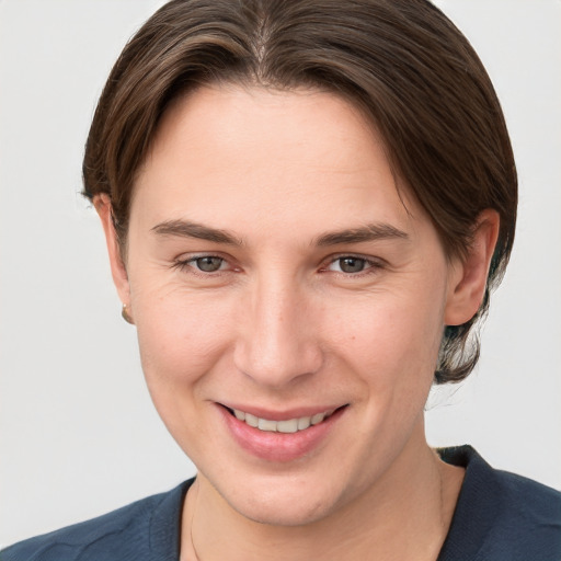 Joyful white young-adult female with short  brown hair and grey eyes