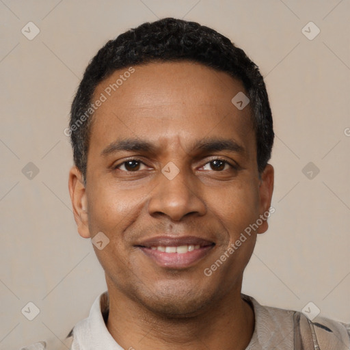 Joyful black young-adult male with short  black hair and brown eyes