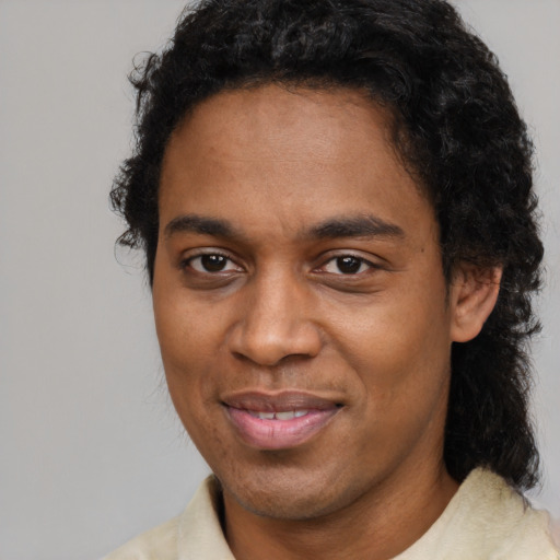 Joyful black young-adult male with short  brown hair and brown eyes