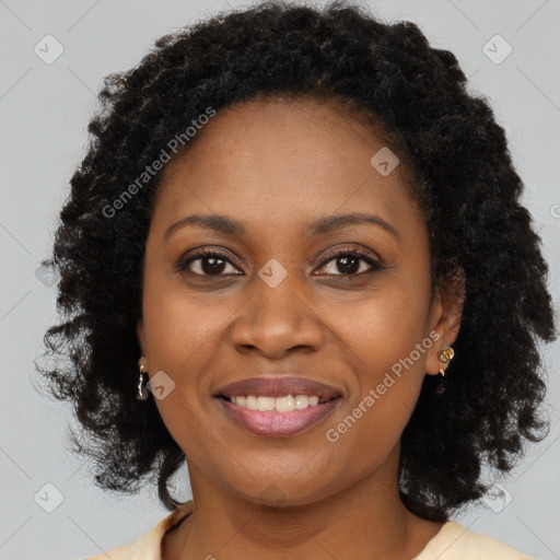 Joyful black young-adult female with long  brown hair and brown eyes