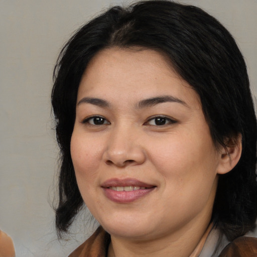 Joyful asian young-adult female with medium  brown hair and brown eyes