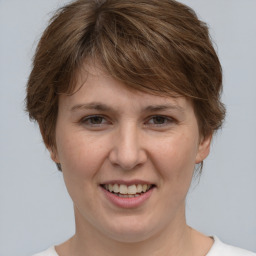 Joyful white adult female with medium  brown hair and grey eyes