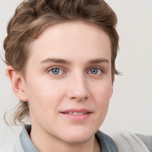 Joyful white young-adult female with short  brown hair and blue eyes