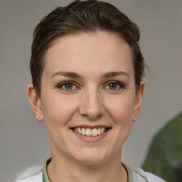 Joyful white adult female with short  brown hair and grey eyes