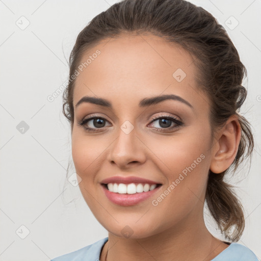 Joyful white young-adult female with medium  brown hair and brown eyes