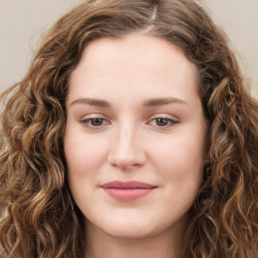 Joyful white young-adult female with long  brown hair and green eyes