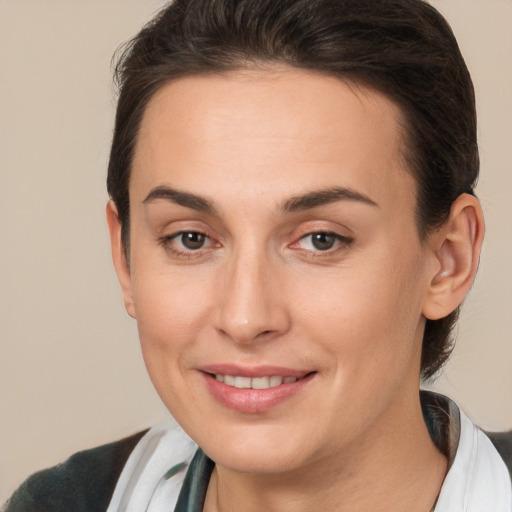 Joyful white young-adult female with short  brown hair and brown eyes