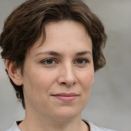 Joyful white adult female with short  brown hair and brown eyes