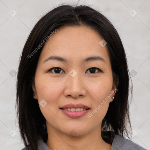 Joyful asian young-adult female with medium  brown hair and brown eyes