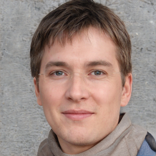 Joyful white young-adult male with short  brown hair and blue eyes