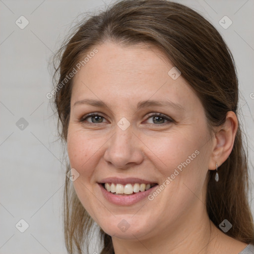 Joyful white adult female with medium  brown hair and grey eyes