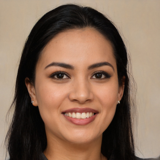 Joyful latino young-adult female with long  brown hair and brown eyes