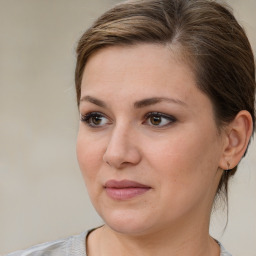 Joyful white young-adult female with medium  brown hair and brown eyes