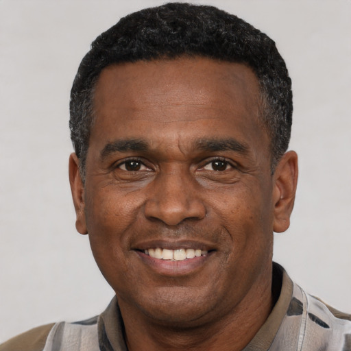 Joyful latino adult male with short  black hair and brown eyes