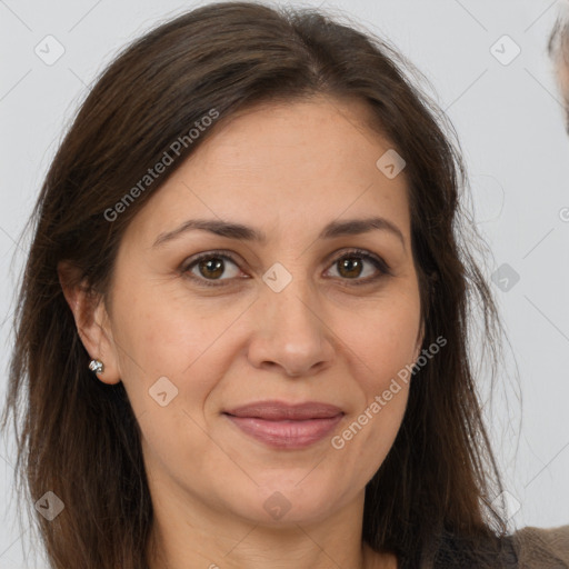 Joyful white adult female with long  brown hair and brown eyes