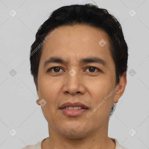 Joyful latino adult male with short  black hair and brown eyes