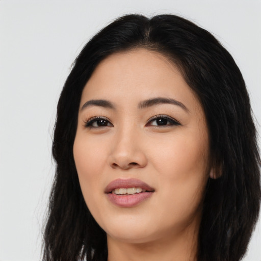 Joyful asian young-adult female with long  black hair and brown eyes