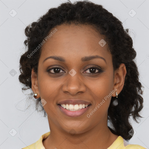 Joyful black young-adult female with long  brown hair and brown eyes