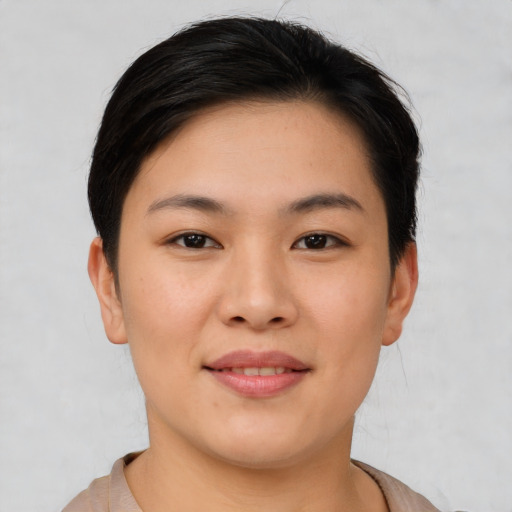Joyful asian young-adult female with short  brown hair and brown eyes