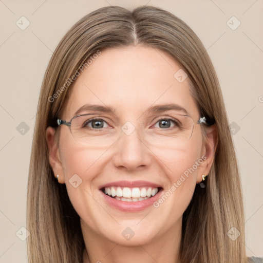 Joyful white adult female with long  brown hair and grey eyes