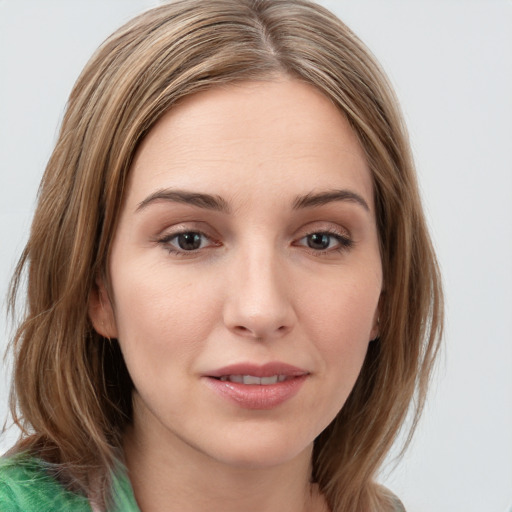 Joyful white young-adult female with long  brown hair and green eyes