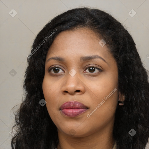 Joyful black young-adult female with long  black hair and brown eyes