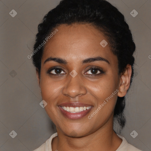 Joyful black young-adult female with short  black hair and brown eyes