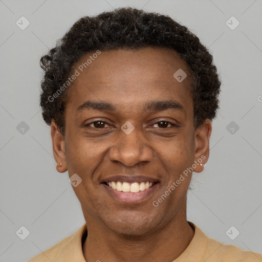 Joyful black young-adult male with short  brown hair and brown eyes