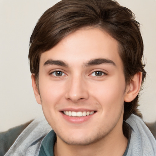 Joyful white young-adult male with medium  brown hair and brown eyes