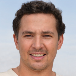 Joyful white adult male with short  brown hair and brown eyes