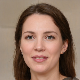 Joyful white young-adult female with medium  brown hair and grey eyes