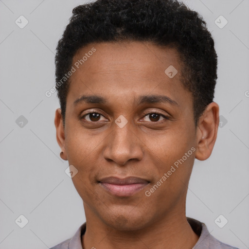 Joyful black young-adult male with short  brown hair and brown eyes